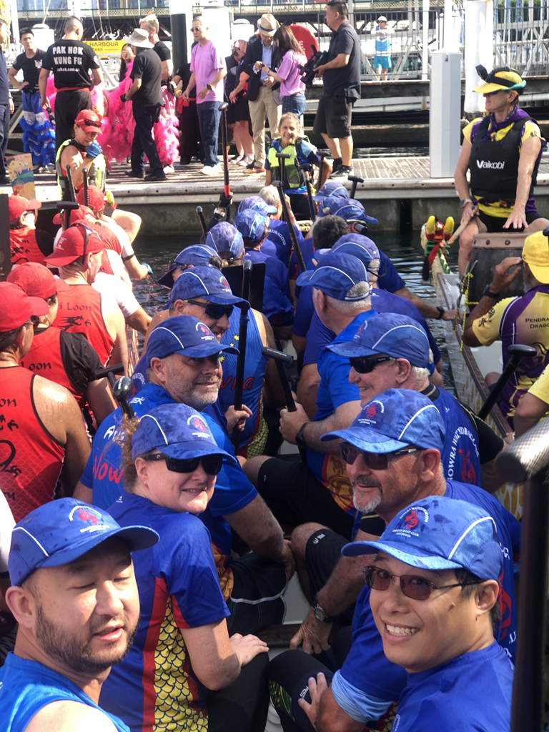 Mixed crew of dragon boat paddlers