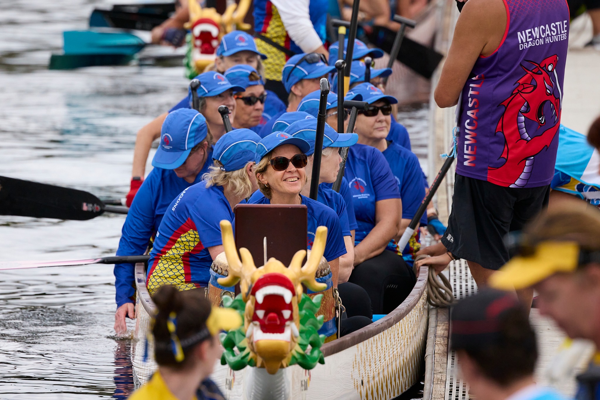Paddlers seated in a dragon boat 